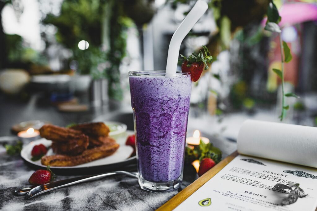 Close-up of a fresh blueberry smoothie with a strawberry garnish, perfect for a healthy treat.