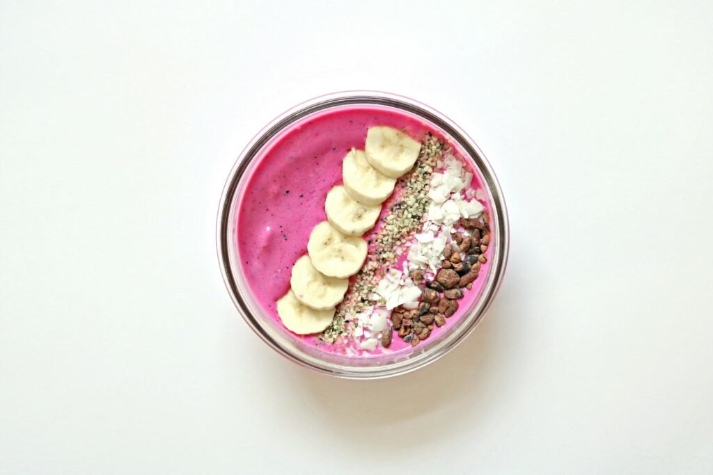 Colorful açaí bowl featuring banana slices, chia seeds, and coconut flakes for a healthy start.